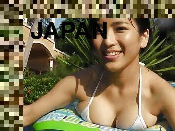 Swimming Japanese girl is stunning in a white bikini