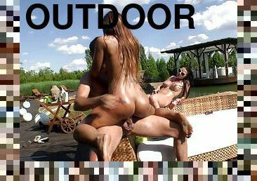 Everyone is covered in oil in this outdoor threesome