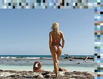 Tanned blonde teen taking two in the sea