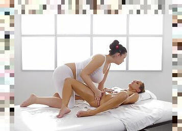 A hot stacked masseuse plays with a lesbian's oiled vagina.