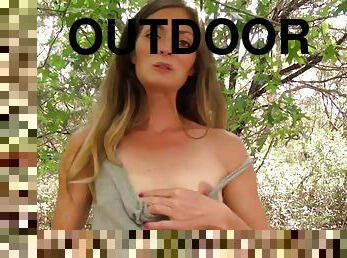 Michelle with small tits fingering her pussy outdoors in the forest