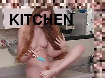 Sweet redhead Nicole B. takes off her red lingerie in the kitchen