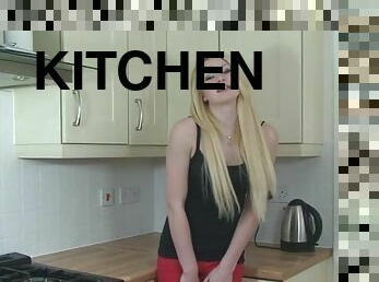 Blonde chick Tegan loves rubbing her pussy with a toy in the kitchen