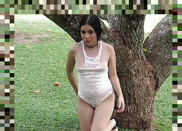 Alluring Latina teen posing under tree