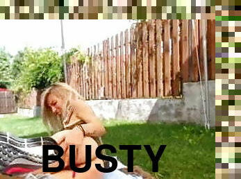 Busty MILF masturbates in the backyard