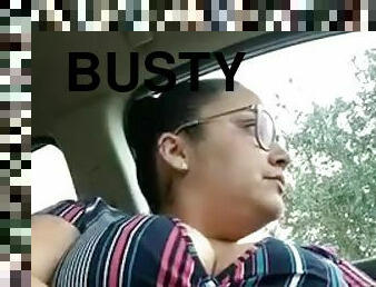 Busty woman in glasses masturbates in car