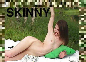 Skinny brunette teen slut Nelya strokes her pussy outdoors