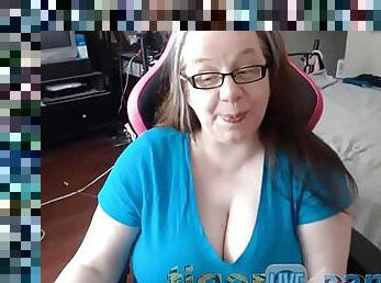 Mature nerdy MILF exposes her huge natural tits on a chair