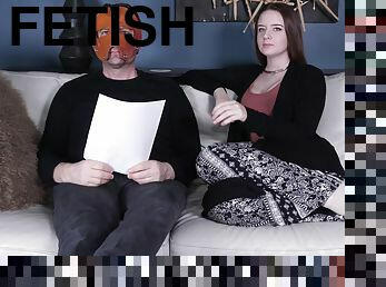 Jessica Kay talks with a masked man backstage at a fetish porn set
