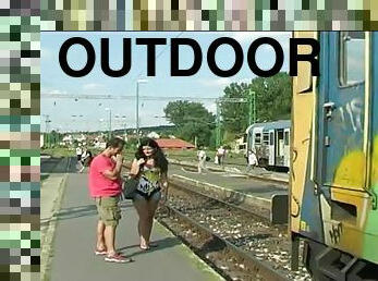 Judy Carmell is outdoors walking along the railroad tracks