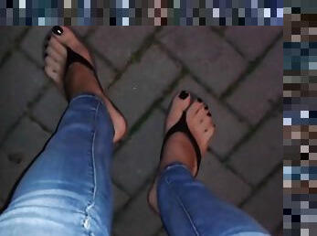 Glossy black toe nail polish and platform flip flops