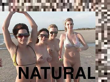 Models with natural tits,in bikini flash their bodies on the beach outdor