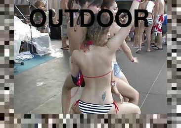 Tattooed pornstars in bikini dancing wildly in a party outdoor in reality shoot