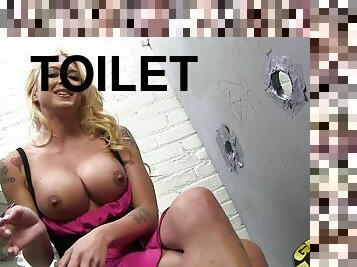 Hot blonde on the toilet showing off her big firm tits