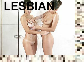 Curvy lesbian with long dark hair touching her girlfriend's hot body