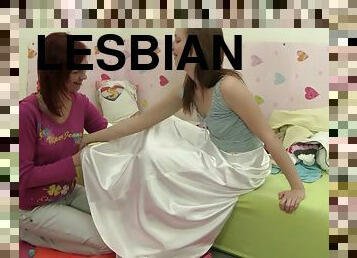 Lesbian coeds have an erotic hook up in bed as they rub pussies