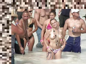 Topless beach party girls enjoy the attention their tits get