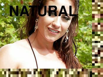 Curvy brunette, Eva Notty, wearing bikini, fingers her pussy in a pool