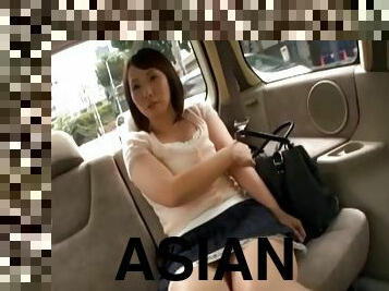 Pretty Asian cougar with a nice ass playing with her wet pussy in a car