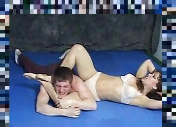 Chick wrestling with a guy and beating him up