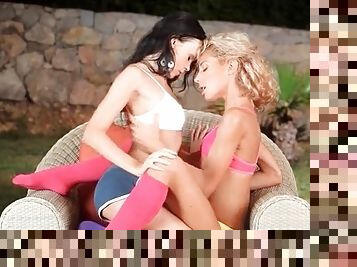 Skinny teen lesbians kiss with passion outdoors