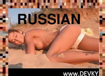 Russian beauty teasing herself on the hot sand
