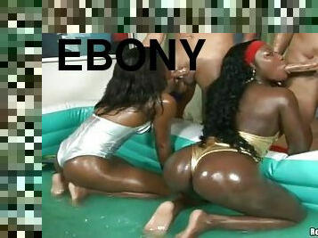 Two ebony sluts oil their big butts and jump on their men's cocks