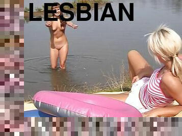 Brunette lesbian drill their cunts with a dildo outdoors