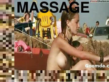 Girl massaged nude at the beach
