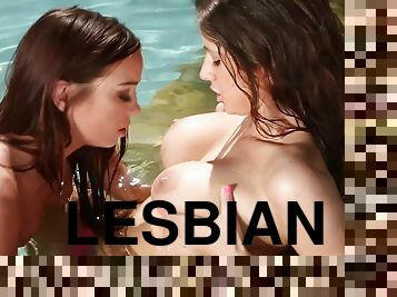 Steamy lesbians suck each other's tits and make out by the pool