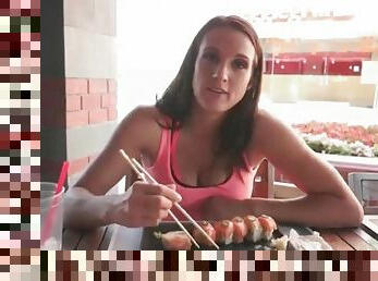 Misty Anderson eats sushi at an outdoor restaurant