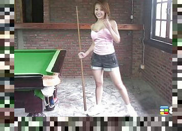 Cute girl takes off her clothes while playing a game of billiard
