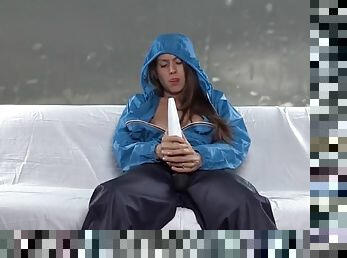 Girl in rain clothes masturbates with a vibrator