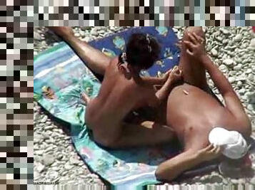 Giving him a handjob at the beach