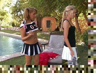 Two sexy blonde cheerleaders have lesbian sex by the pool