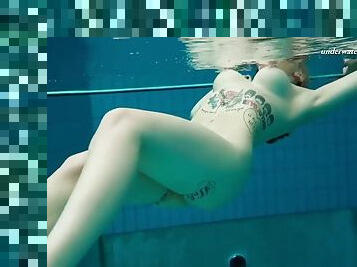 Dashka a sexy gal in lingerie shows her hot tits swimming underwater