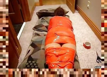 Weird Woman Wrapped In Orange Tape Asleep