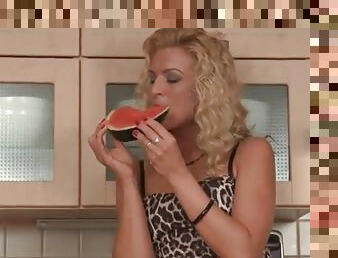 Slutty dress on blonde girl eating watermelon