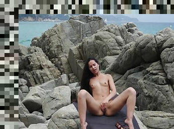 Long haired solo brunette model Monica Brown masturbtaes on the beach