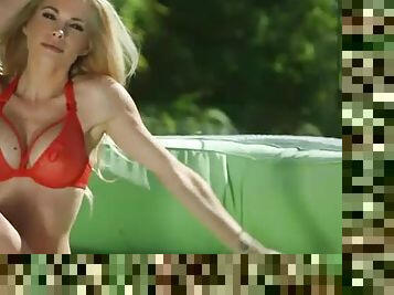 Slim babe Dani Mathers models fake tits outdoors