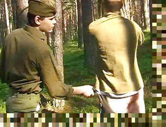 Outdoor spanking scene with two soldiers