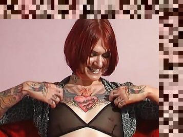 Tattooed redhead chick Tallulah Tease rides a large dildo. HD