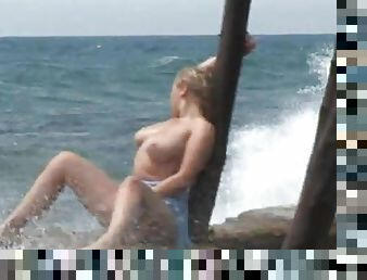 Amazing solo model with big tits masturbating passionately at the beach outdoor