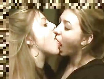 Two beautiful lesbians kissing and licking each other