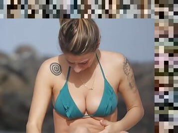Tattooed bikini girl has incredible cleavage