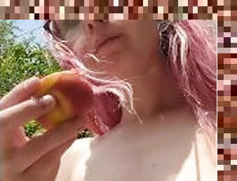 Eating a peach outside with my tits out