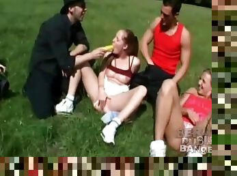 Orgy in a grassy field of a lovely park