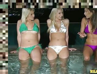 Three babes lick asses and pussies at night in a pool