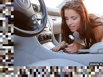 Redhead rides the gear shift in the car