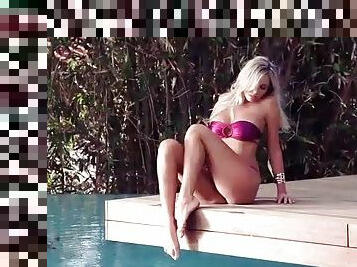 Shiny pink bikini on hot babe Devin Justine outdoors